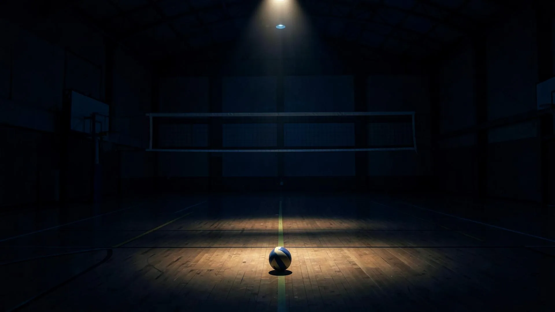 Volleyball on an empty court under a spotlight